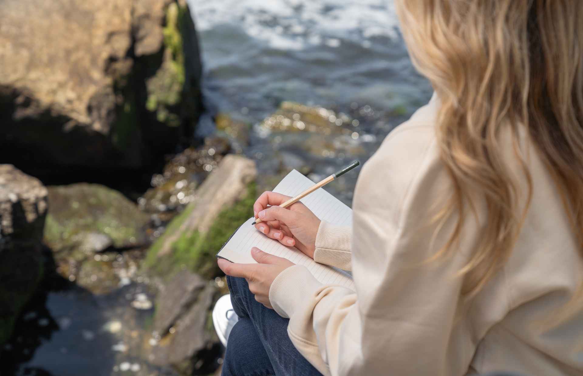 Woman journaling on the beach