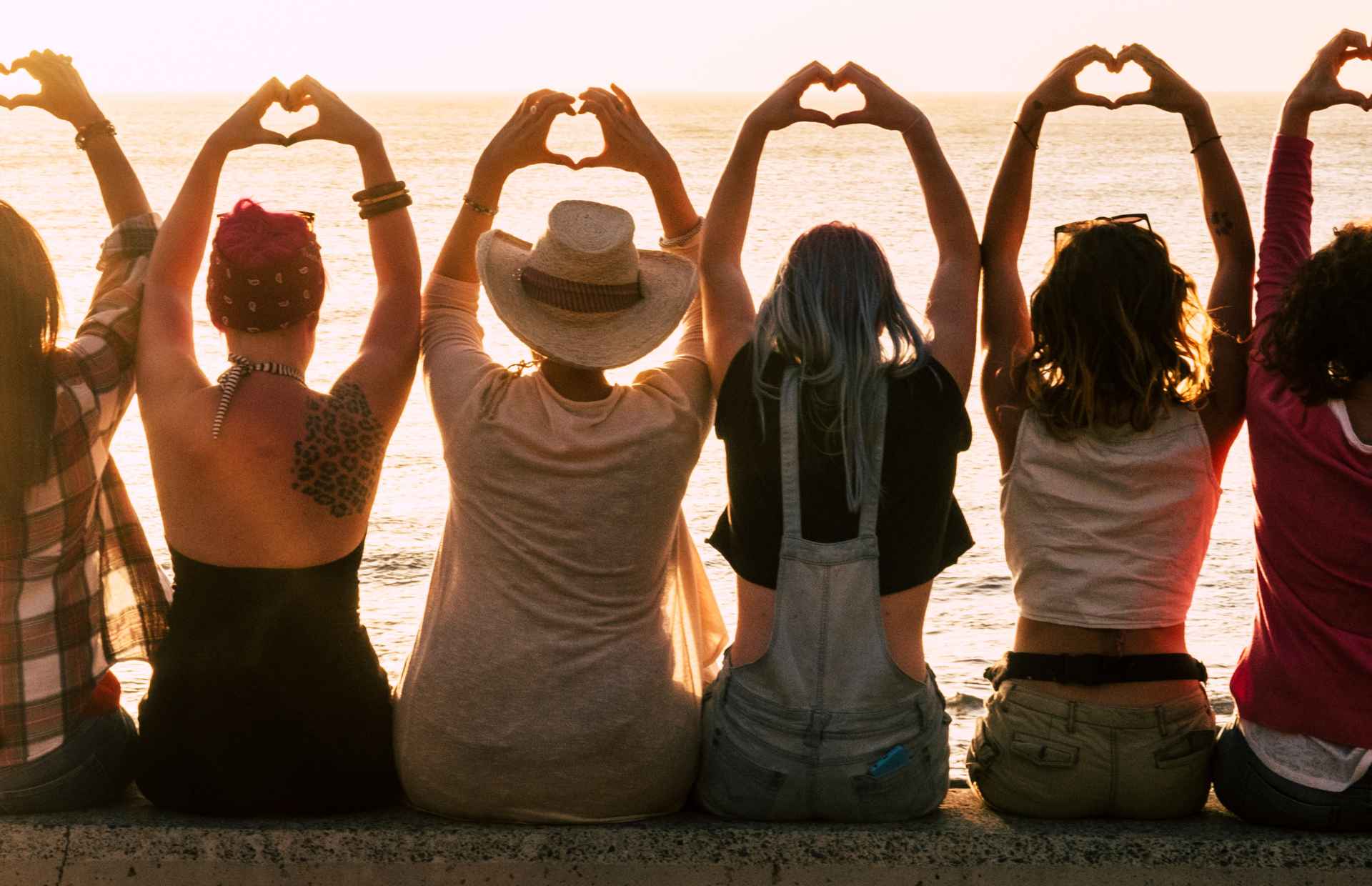 Women sitting together at the beach