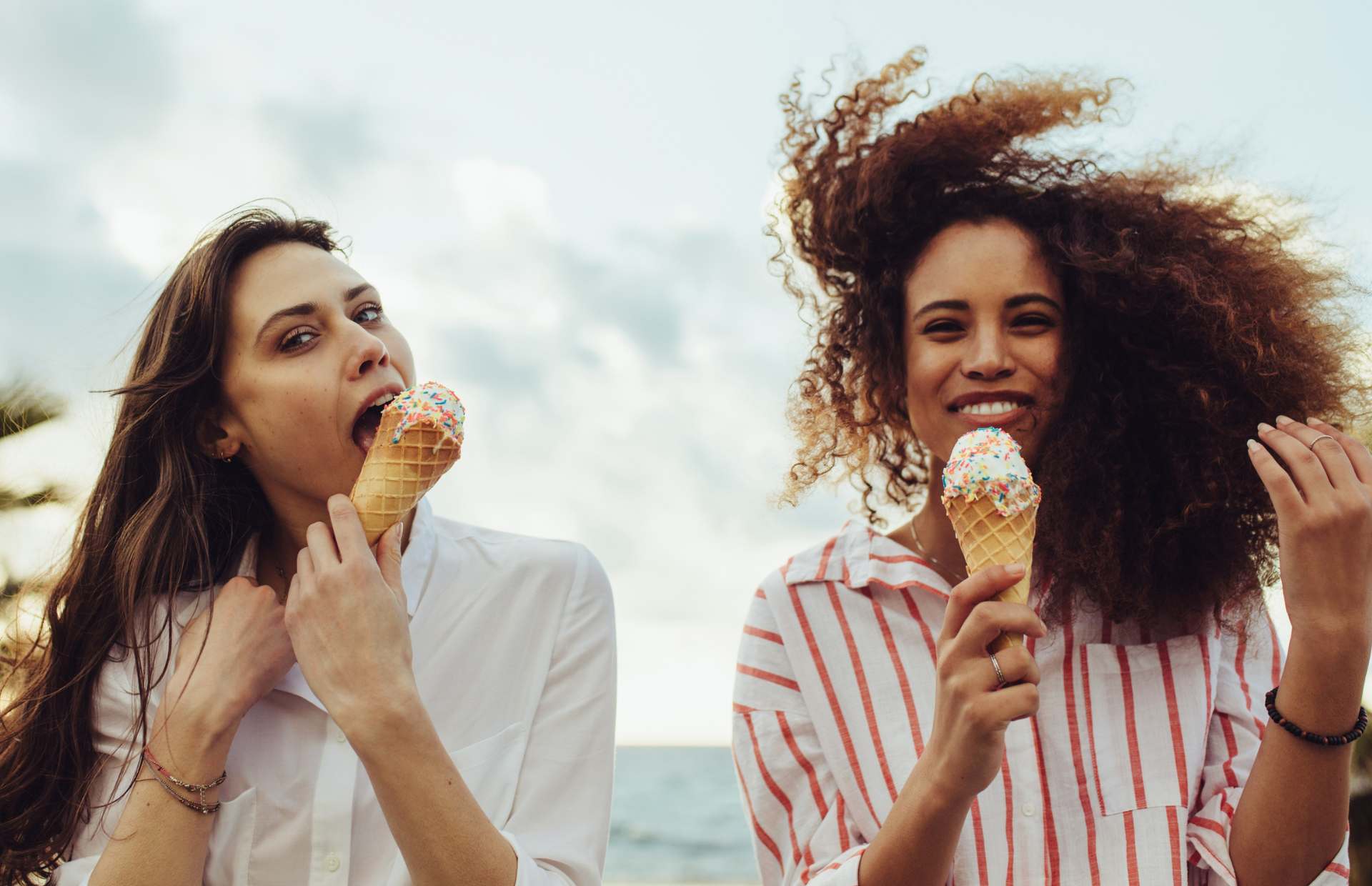 Satisfying taste hunger with ice cream two women eating ice cream