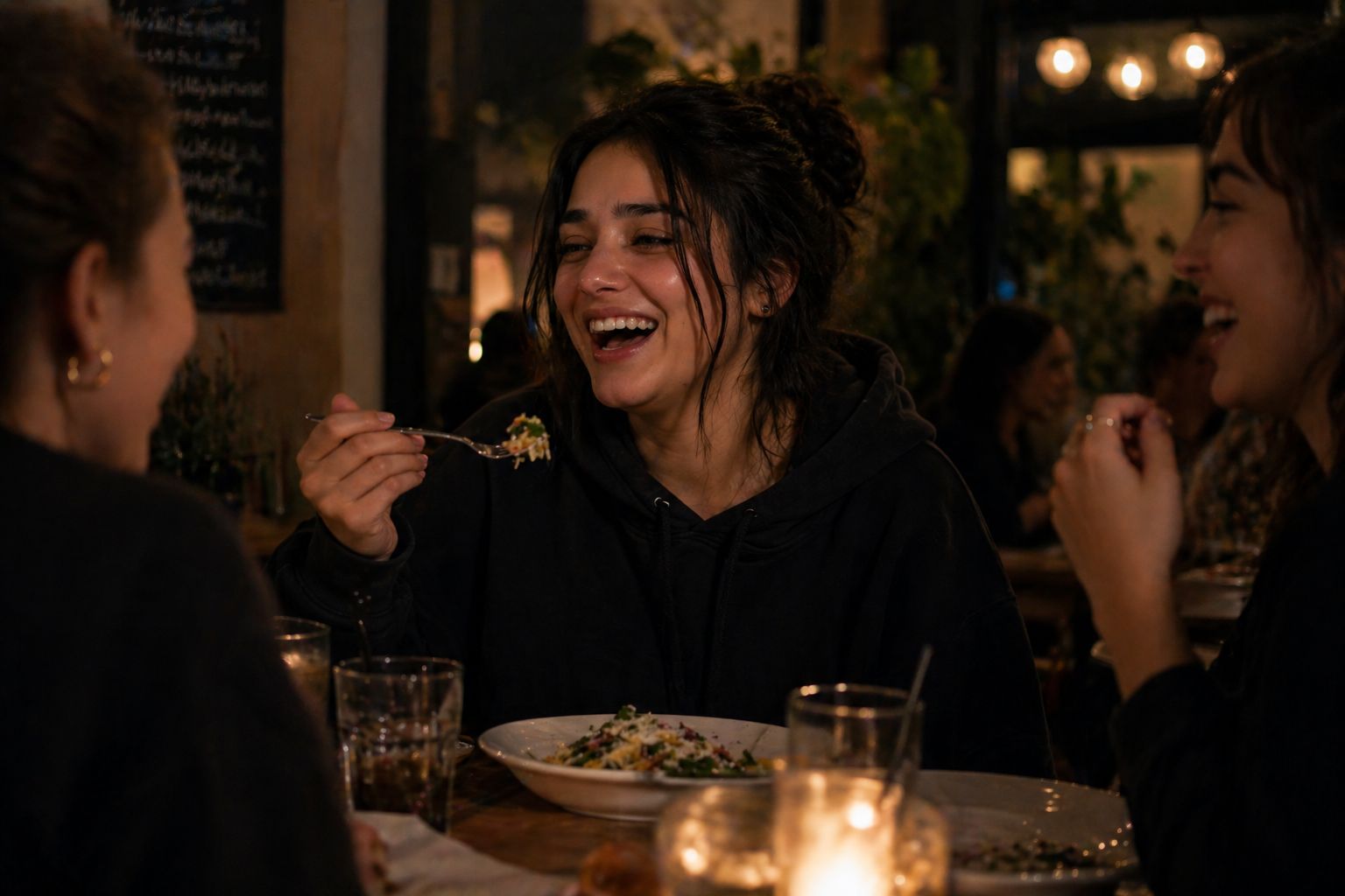 Woman eating out with her friends and laughing